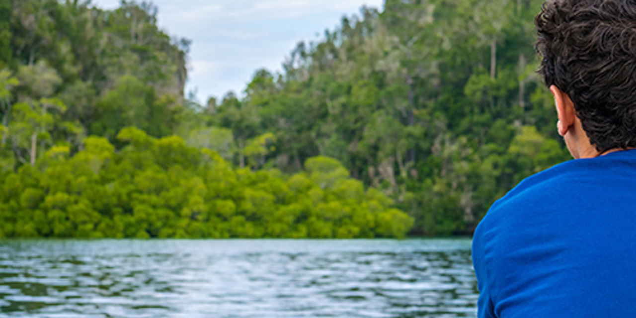 Man sitting at a lake