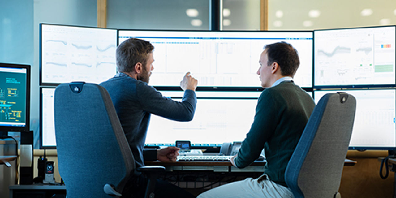 Two men looking at screen discussing PPAs