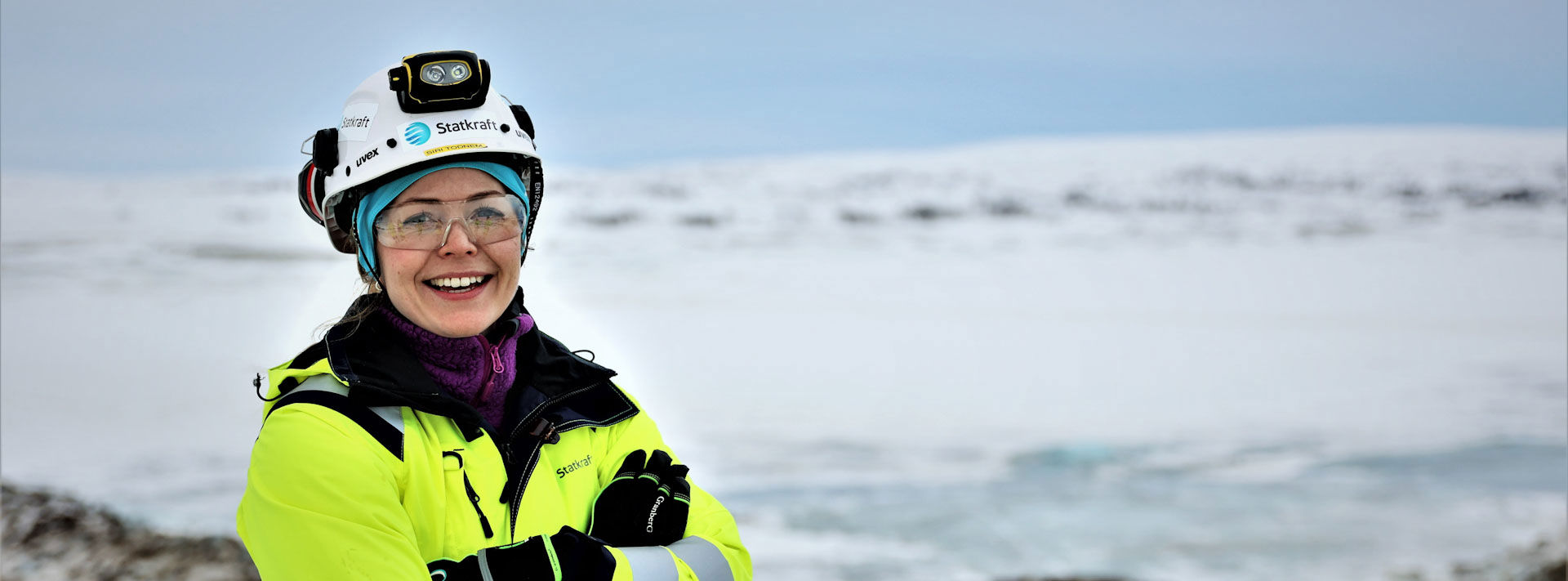 Woman smiling in work attire in snowy mountains